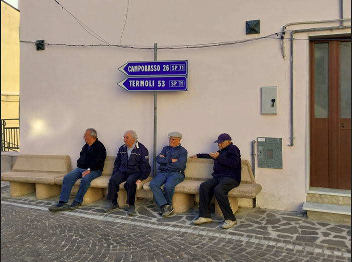 castellino del biferno meeting to care med with locals in molise, 4 old people sitting under the street sing in silence ofthe city
