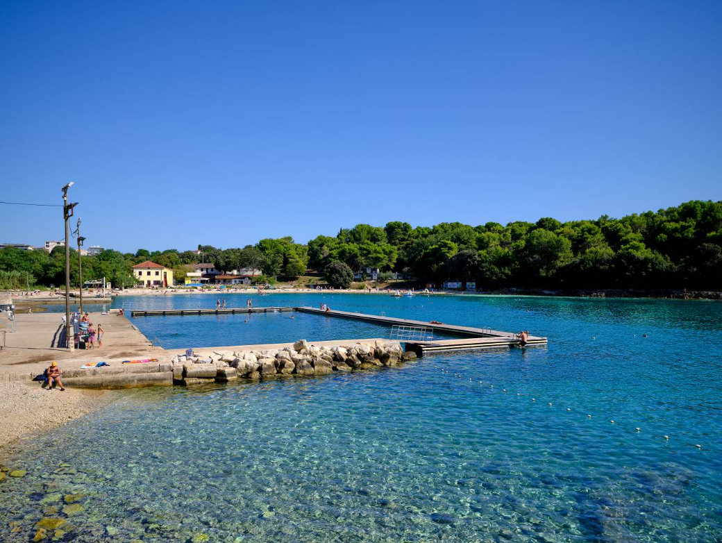 pula valsaline blue beach and te forest behind