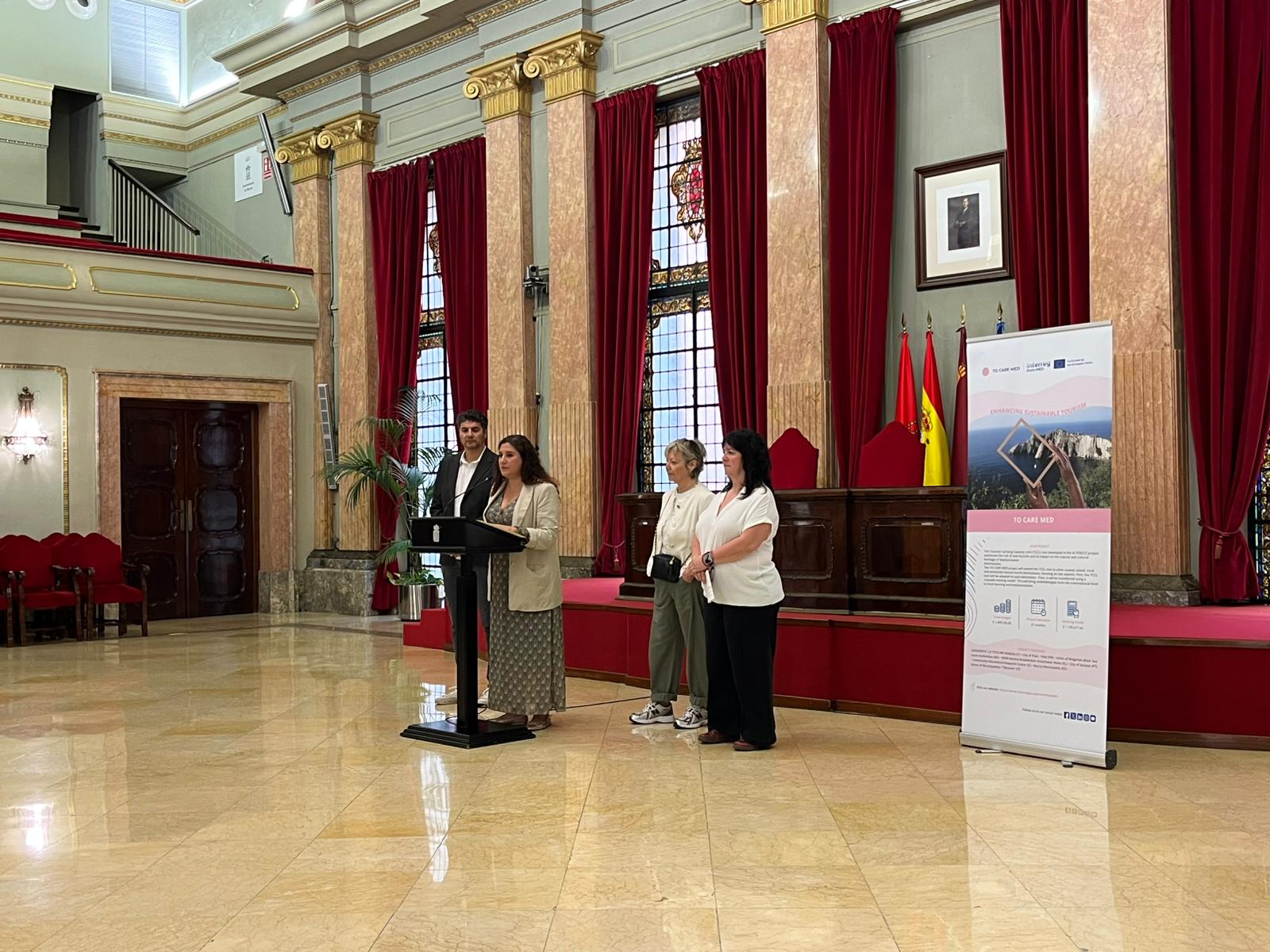 the municipality hall Murcia, where the speakers stand and the red curtains are behind